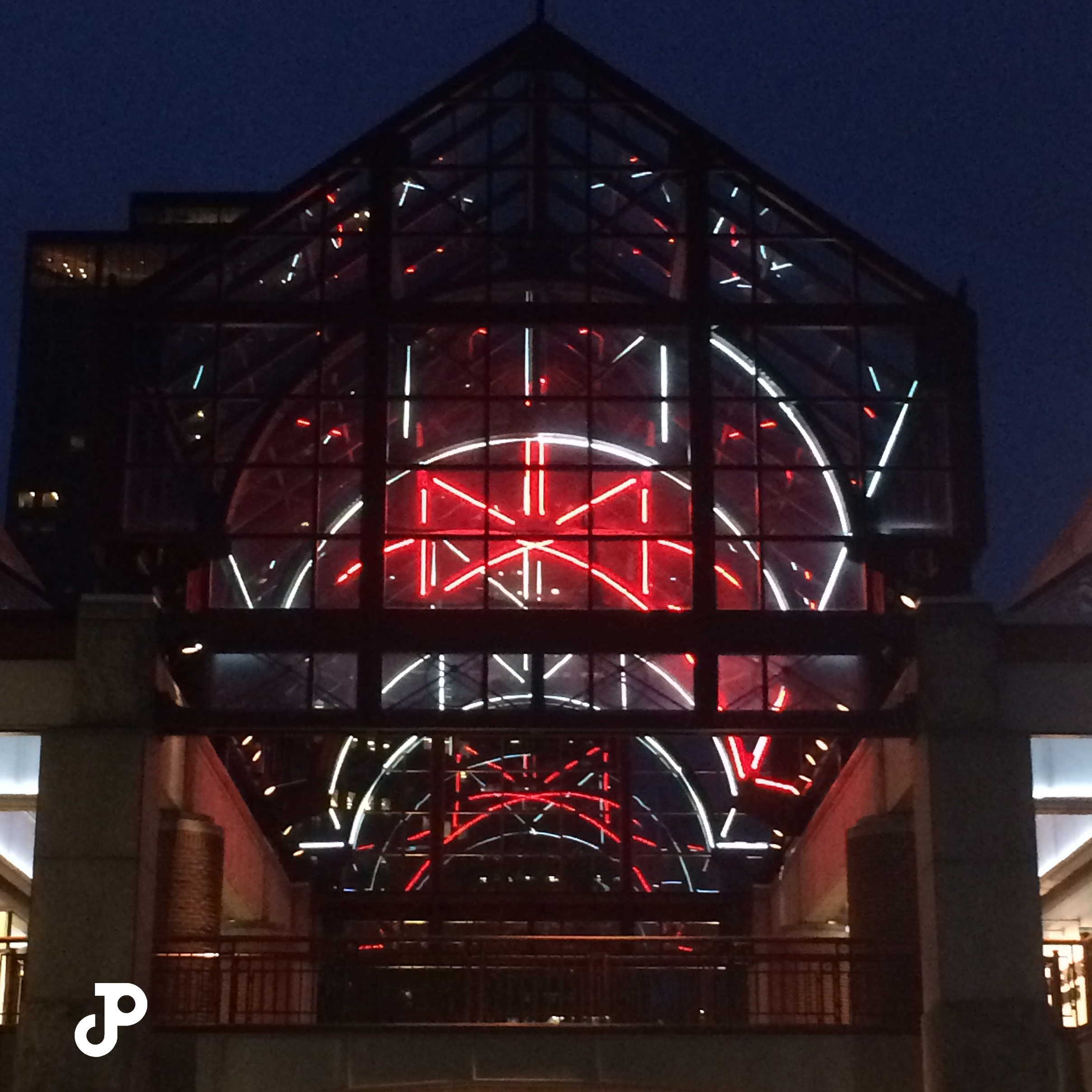 a darkened building highlighted with red neon lights in Faneuil Hall