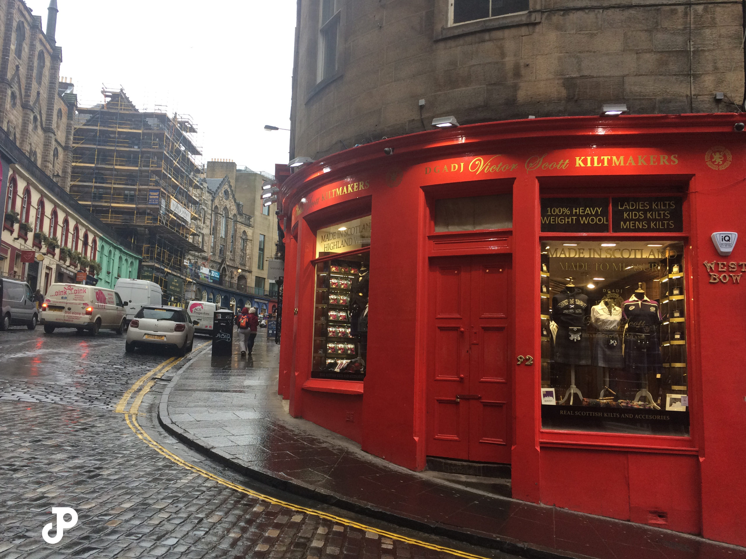 a kilt shop on an upward curving, cobblestoned road