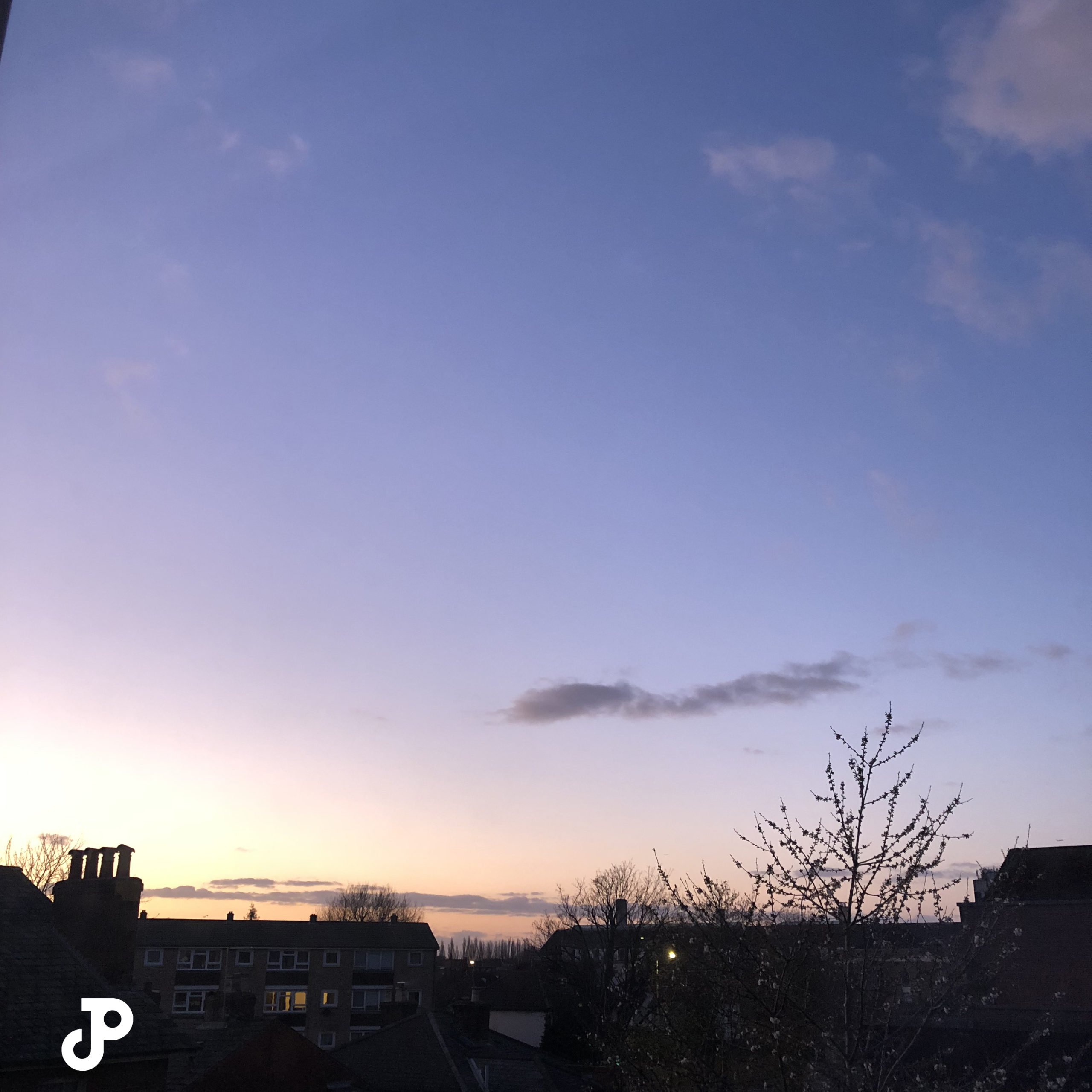 a pink and purple sunset over shadowy rooftops in Kingston Upon Thames, London