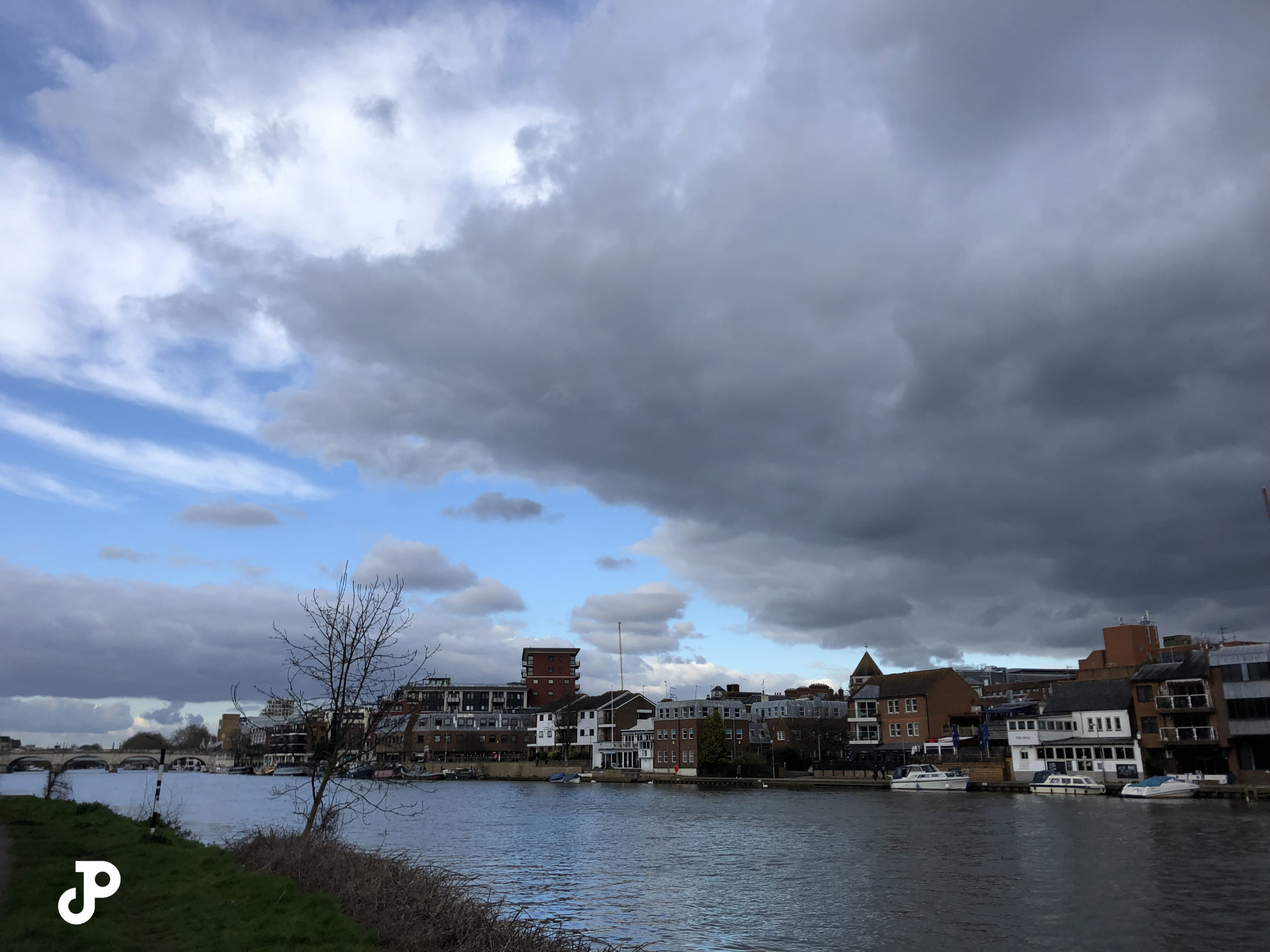 dramatic dark rainclouds closing in part of the sky over the River Thames in Kingston Upon Thames