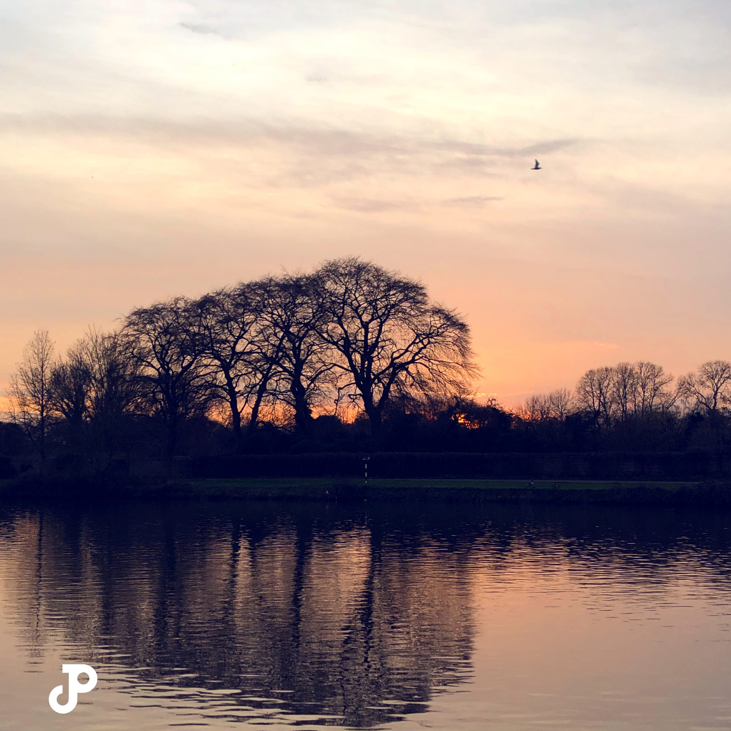 a vibrant orange and pink sunset over the River Thames in Kingston Upon Thames