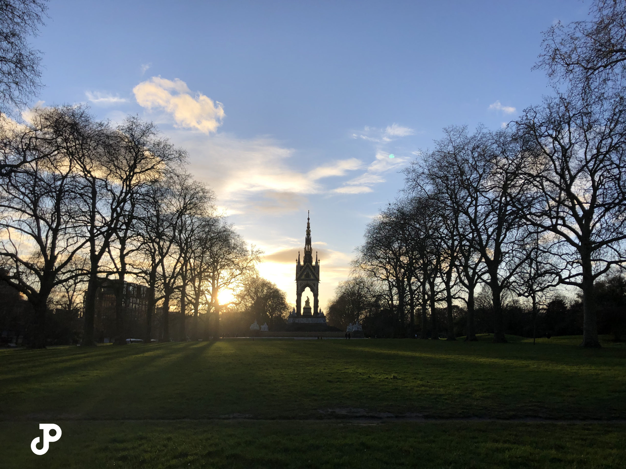 a grassy park with the Albert Memorial in the distance