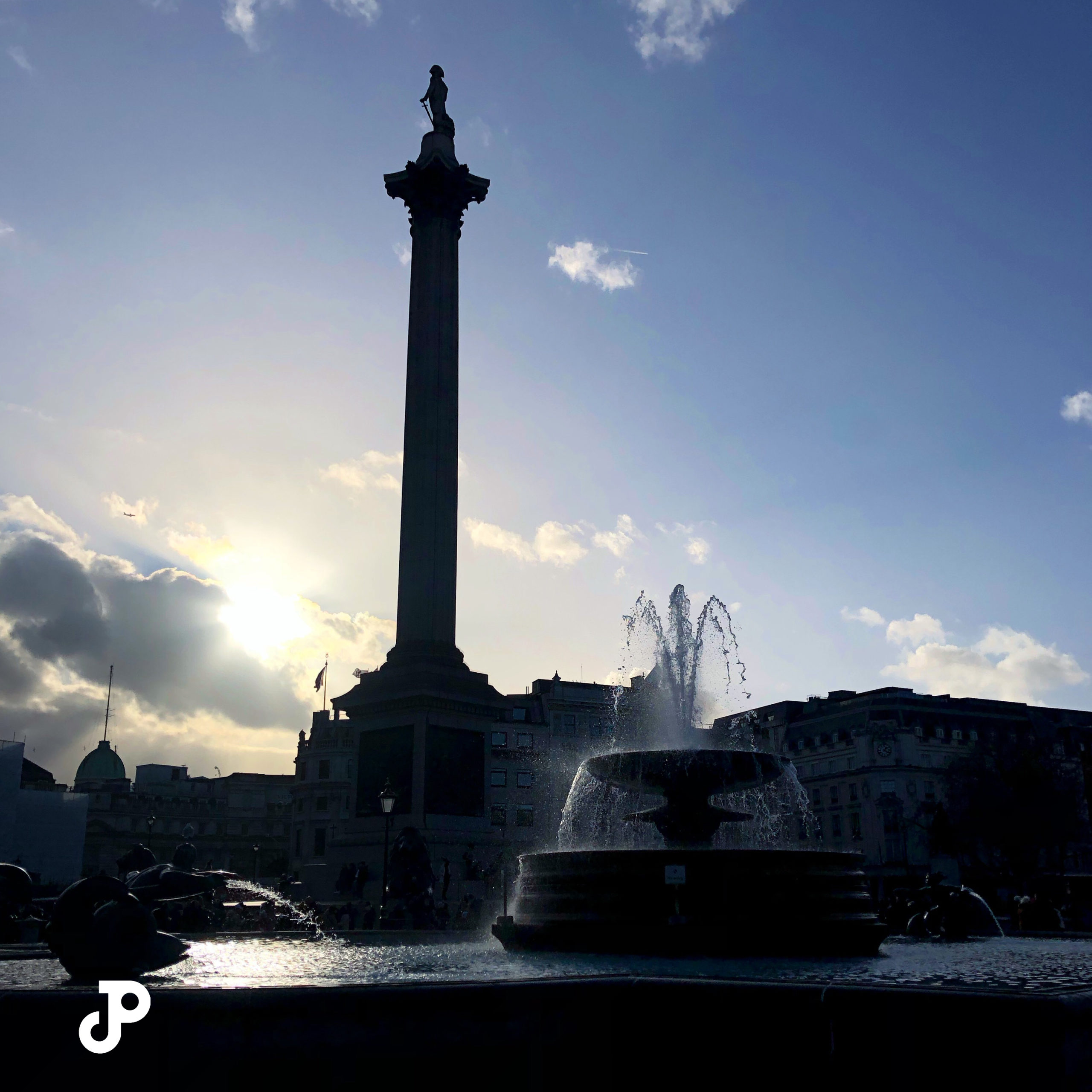 a shadowed view of Nelson's Column in Trafalgar Square, London