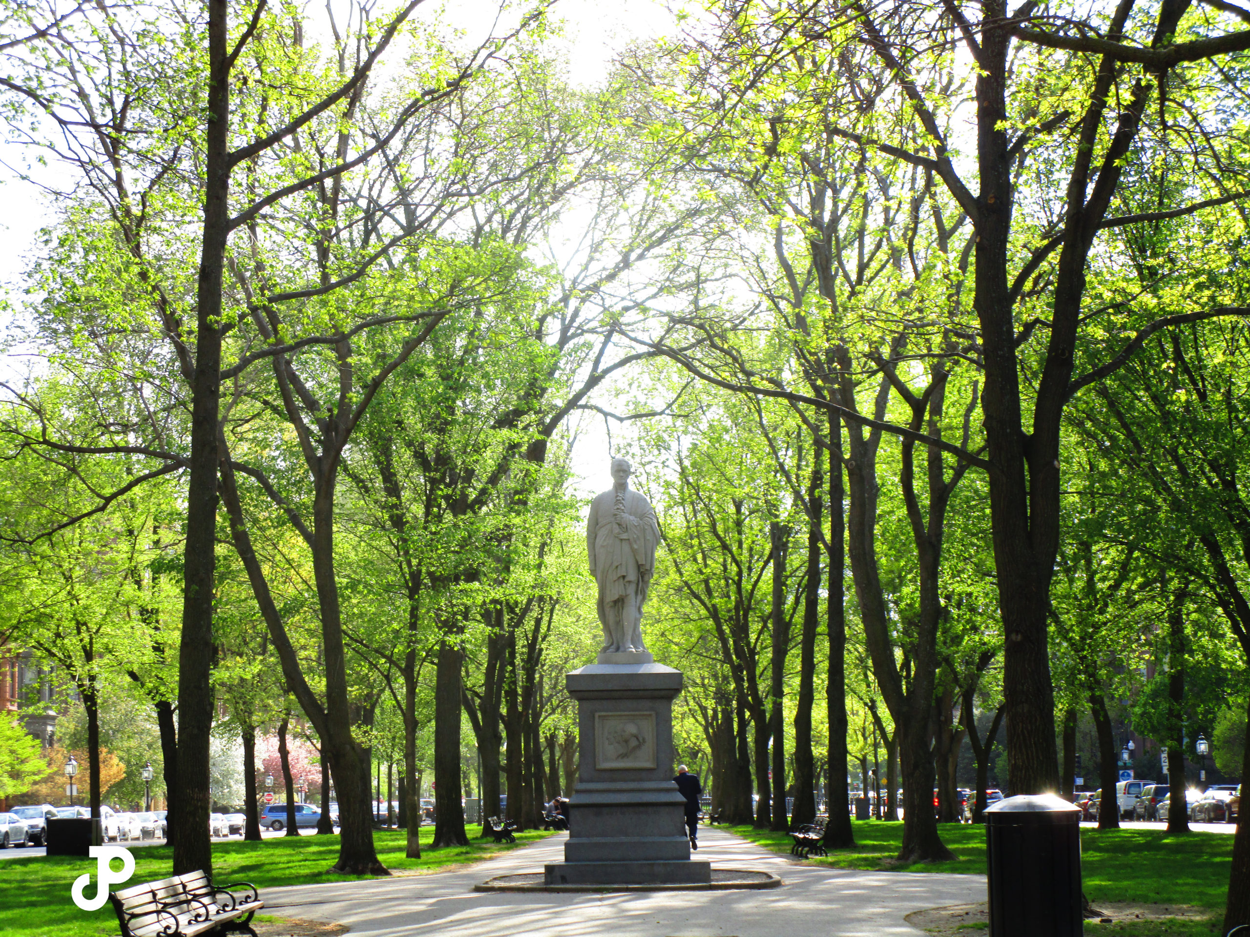 the Alexander Hamilton Statue surrounded by vibrant green trees