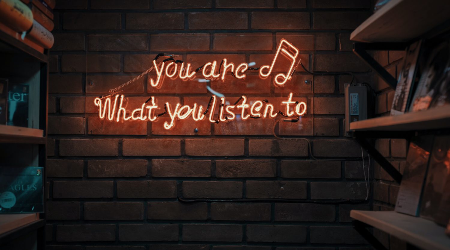 A stylised neon sign that reads you are what you listen to