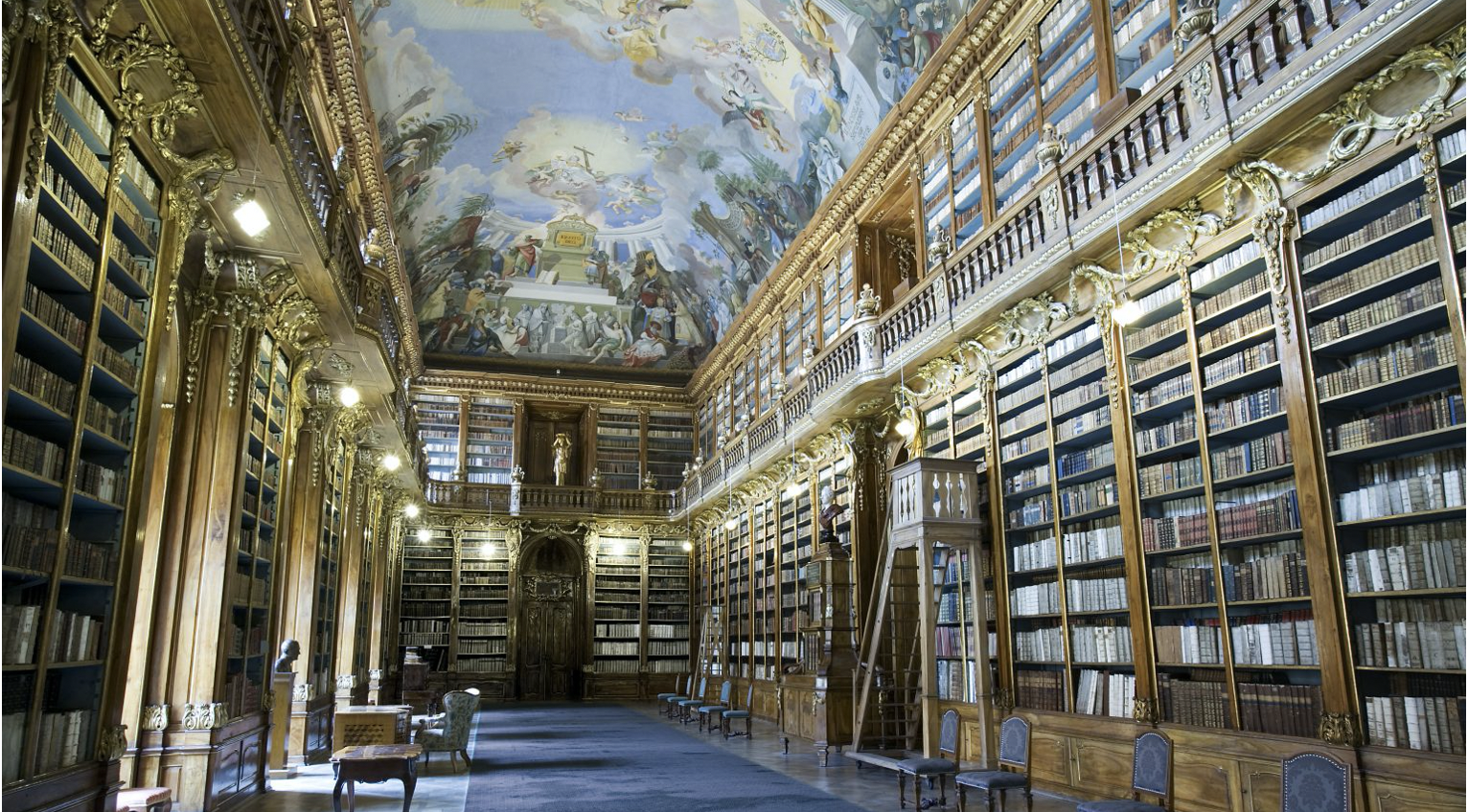 An Enlightenment-era reading room lined with bookshelves that reach to an intricately painted ceiling