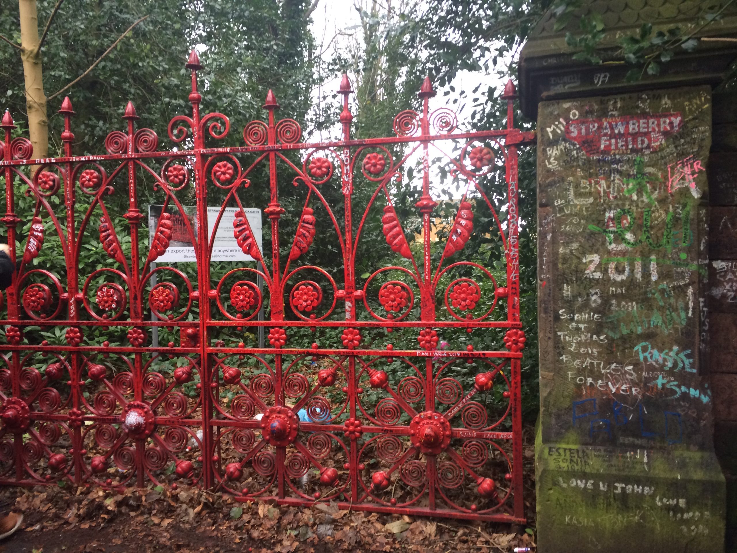 a photo of the red gate and stone wall leading to Strawberry Field