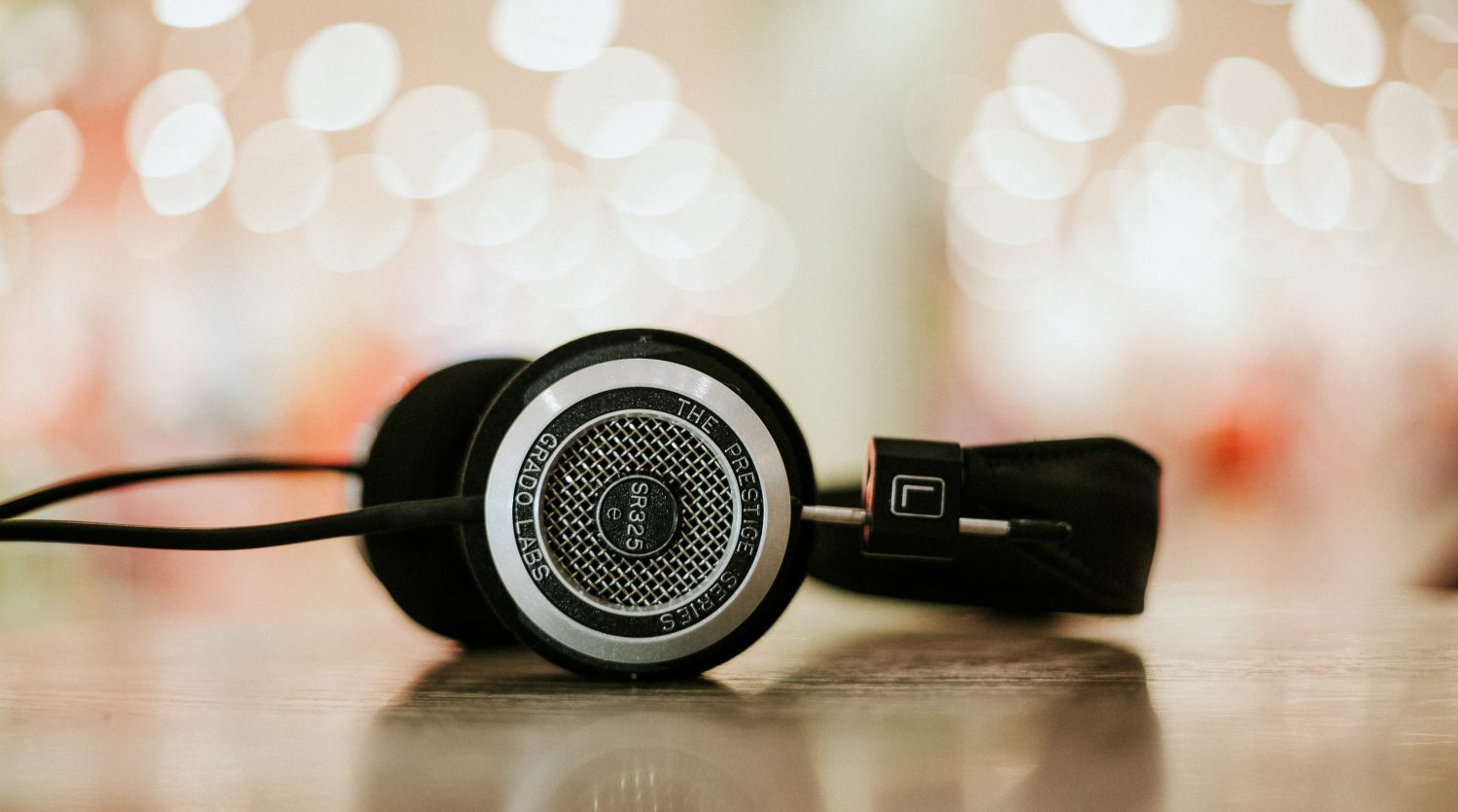 A pair of black headphones lying on a table